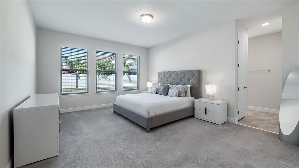 Large Primary Suite features huge walk-in closet and spa-like bath with large corner soaking tub, walk-in shower, quartz countertops, and double vanities.