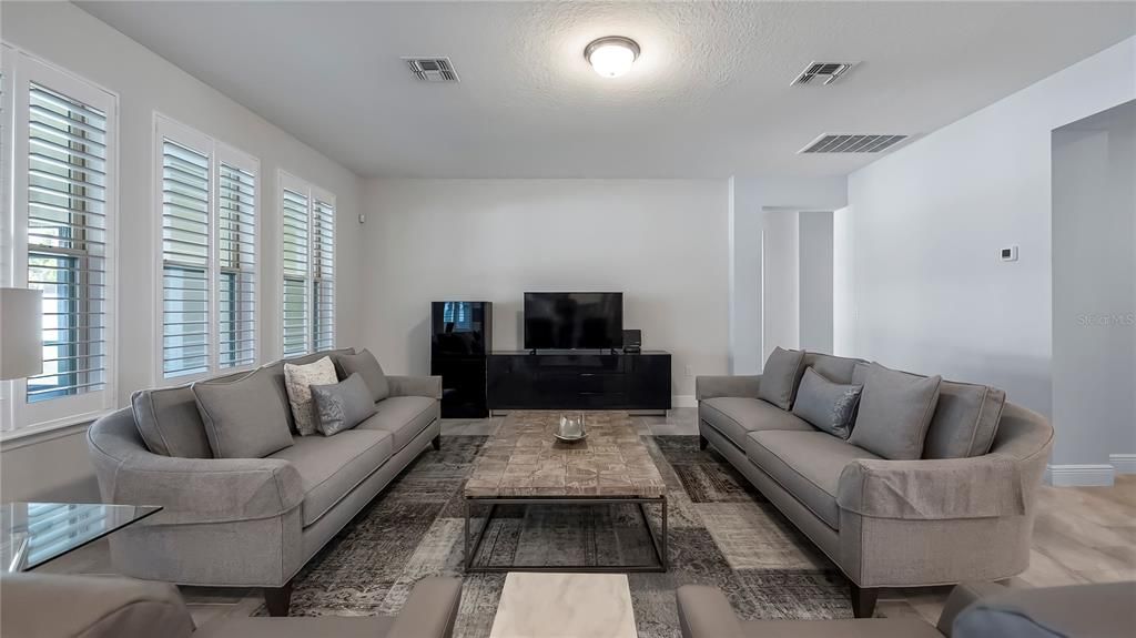 Spacious family room with access to oversized 31-by28-foot covered and screened lanai.