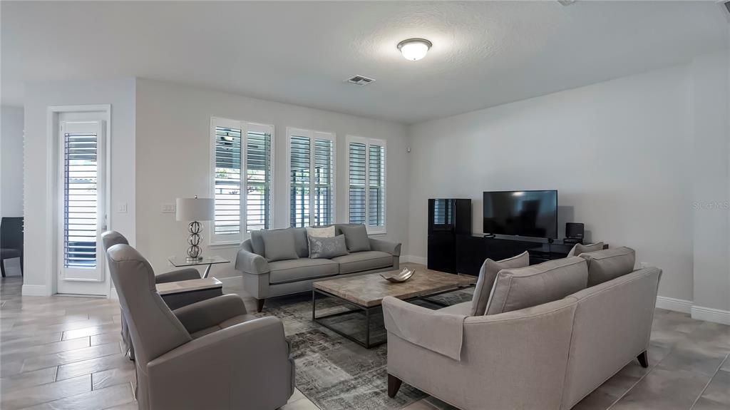 Spacious family room with access to oversized 31-by28-foot covered and screened lanai.