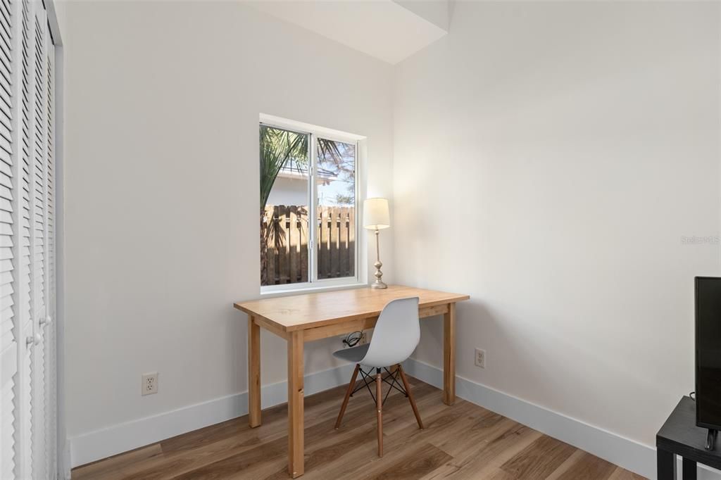 Desk area with picturesque window overlooking side yard.