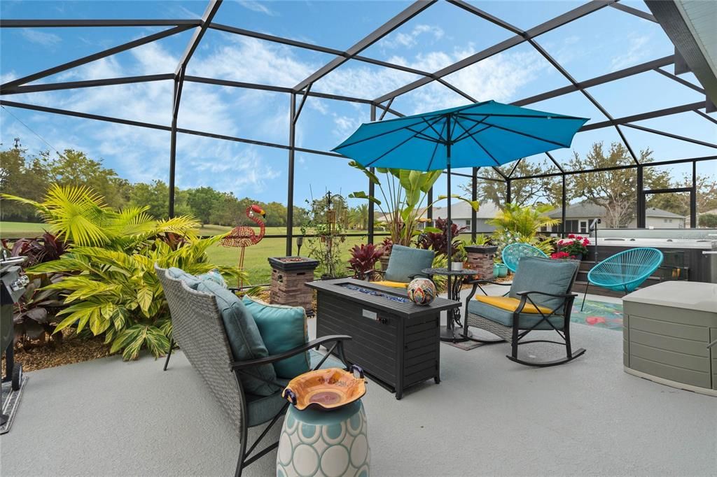 Under the 19x40 screened birdcage. Tropical plants view of 11th fairway and colorful sunsets.