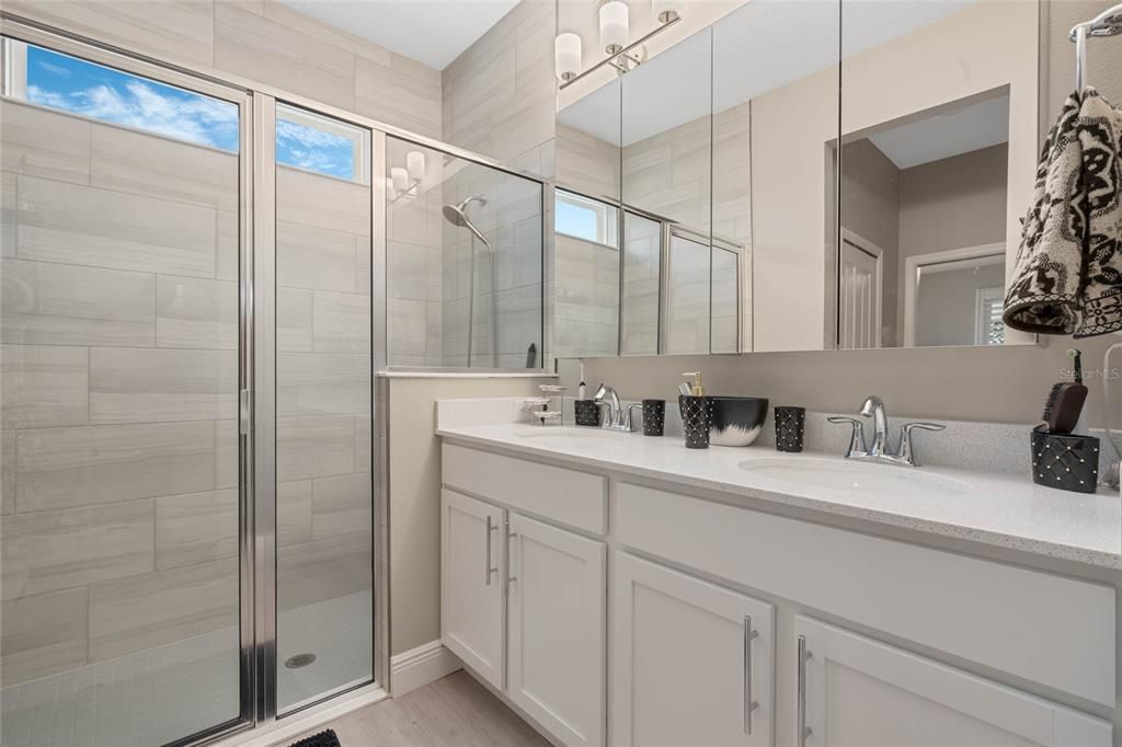 master bathroom. quartz countertops, dual sinks,Shower has floor to ceiling tile