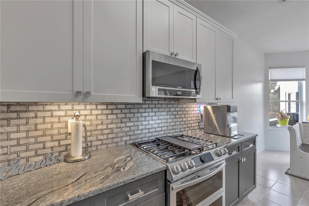 beautiful backsplash with basic  colors to that can go with any color palette. Oven will cook remotely and double oven, conventional .. Appliances are by samsung . gfi outlets throughout and under counter lighting to display your kitchen.  Cabinets and hardware were painted and updated 6/2023 and the paint color is in garage.