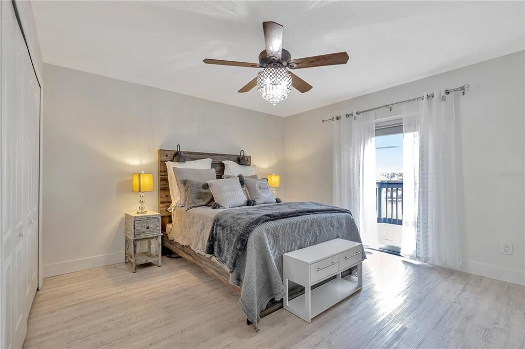 Very peaceful and the natural light is amazing. Noone could be depressed in this house! It feels like every day is a vacation. This bedroom has a custom closet created inside with shelving and for organization.Door to balcony