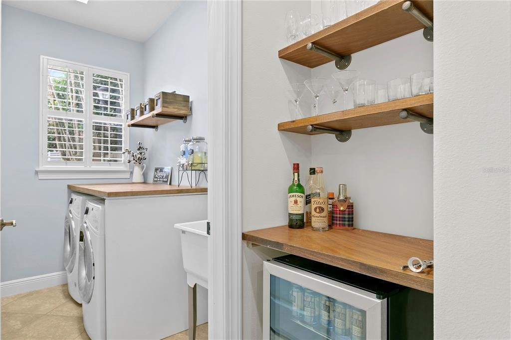 Quaint bar adjacent to kitchen and walk in laundry room