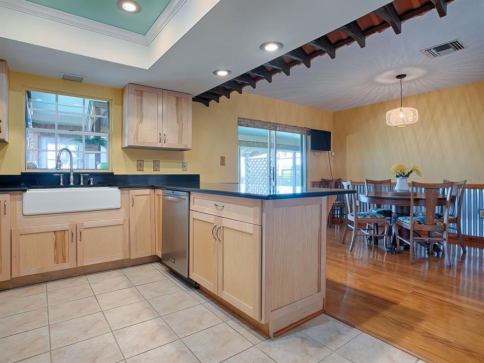 Great kitchen open to the dining area and overlooking the enclosed porch ~