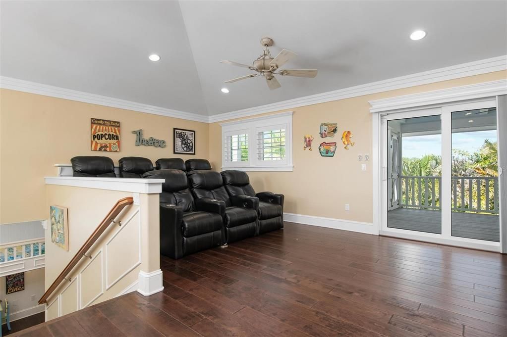 Theater and game room area at the top of the 3rd floor with screened in porch