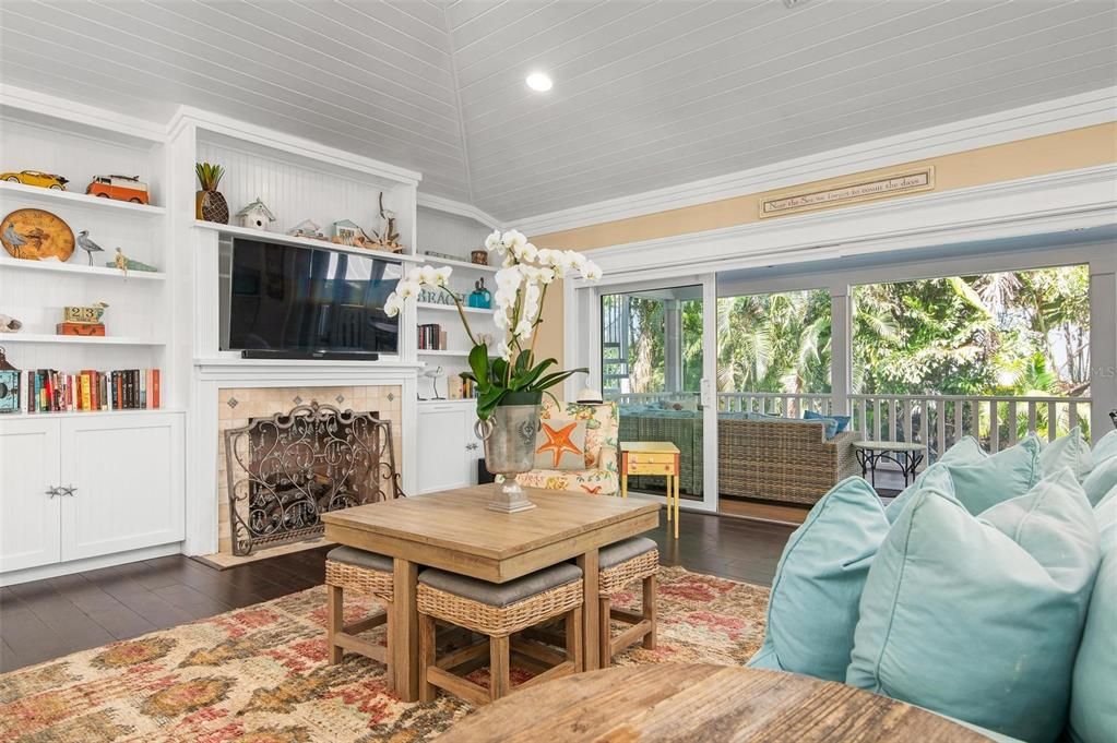 Open concept living,  with gas fireplace and sliders to screened porch