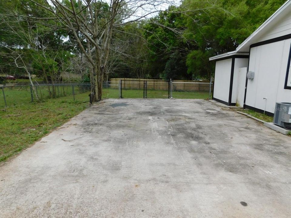 Driveway with a double gate leading to the back yard