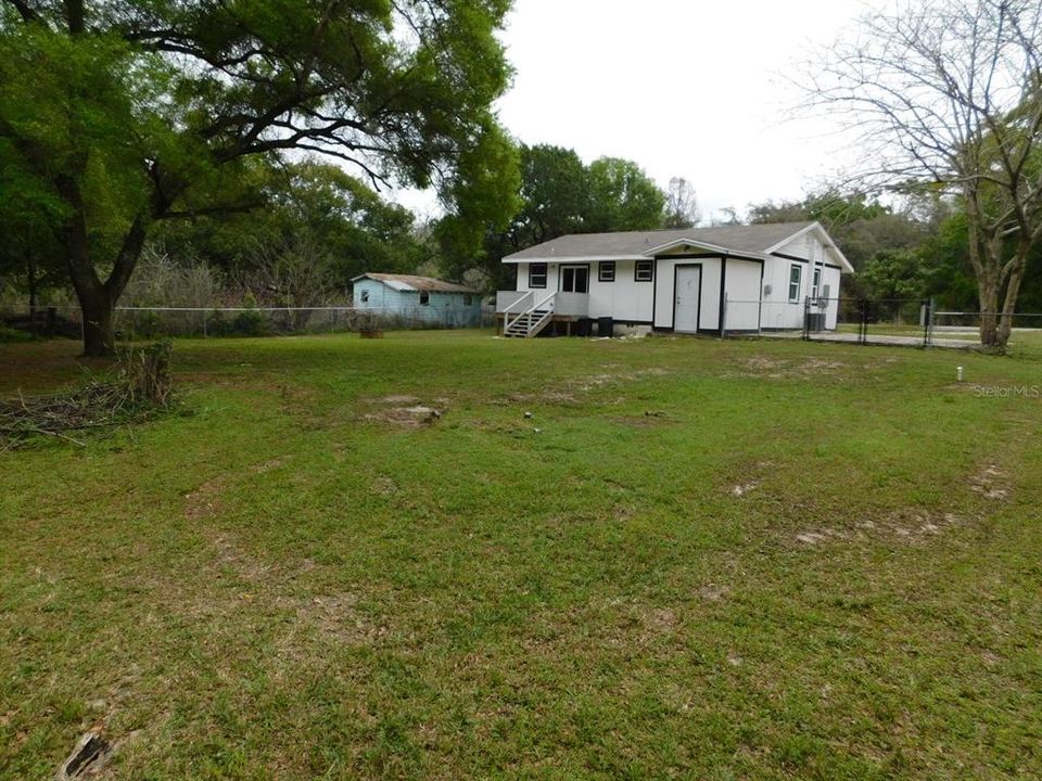 Back of home and yard from the back left corner