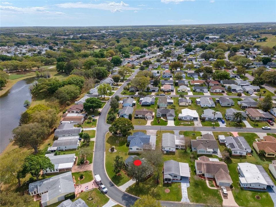 AERIAL - Looking Southeast - Illustrating the rounded corner lot and peaceful setting just minutes from all of the action!