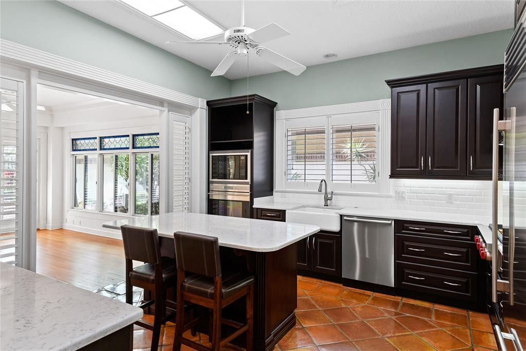 Large Sunlit Kitchen w/ island and opens to Florida Room