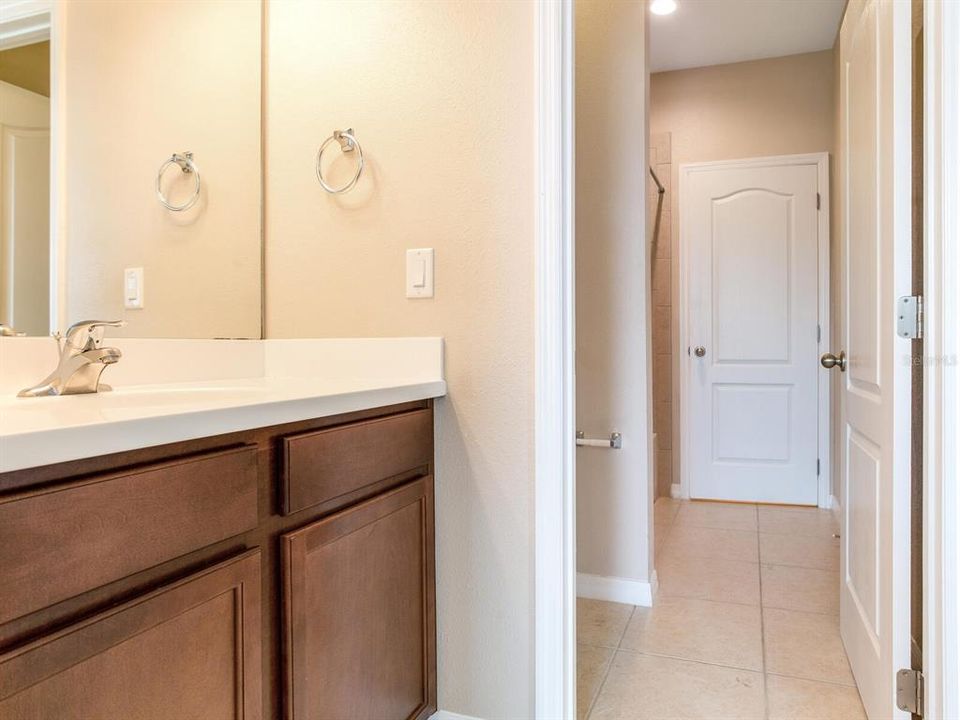 Jack and Jill Bathroom connected to two separate vanity rooms for each room