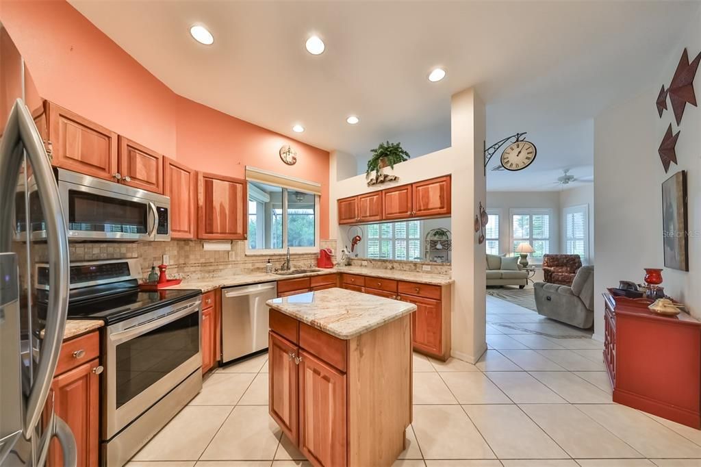 The UPDATED kitchen has recessed lighting, tile flooring throughout, and a large center island.