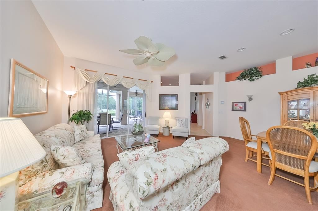 As you walk into the home, you are immediately pulled into the lanai and pool area.  The living room is large, bright and airy.