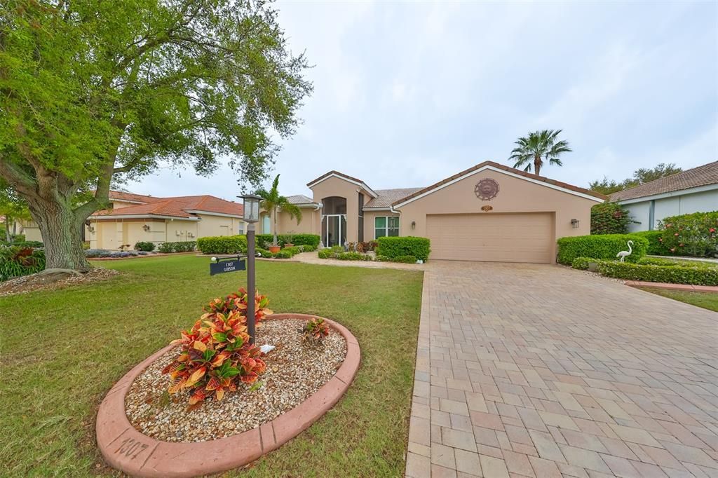 Notice the long custom paved driveway with 2 car garage perfect for extra guests!