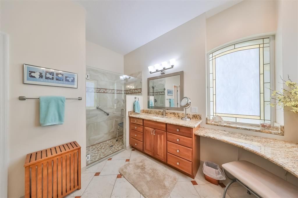 Primary Bathroom includes a ROLL IN shower with modern and handsome tile work.  The large windows bring in lots of natural light.