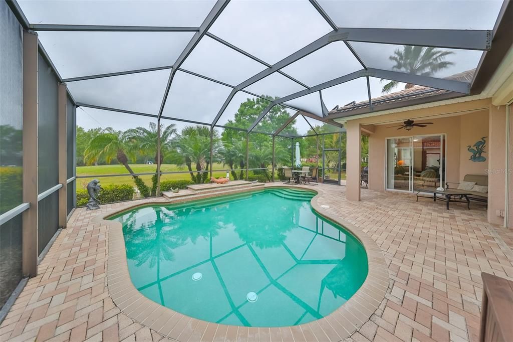 Screened back Lanai w/ HEATED, SALTWATER POOL lined with the"Pebble Tec" pool lining.