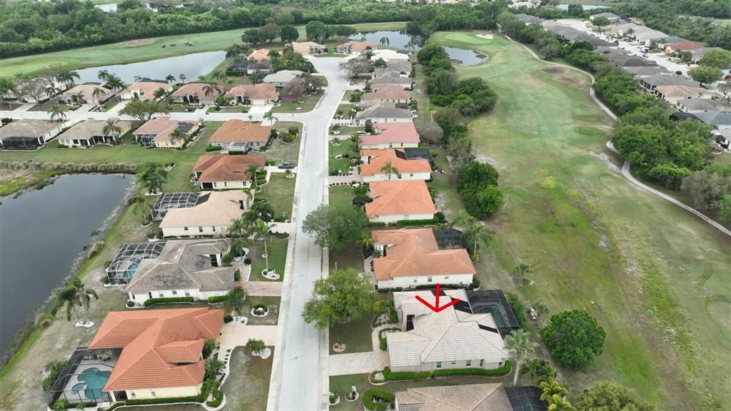 Ariel view of community with home outlined with the red arrow