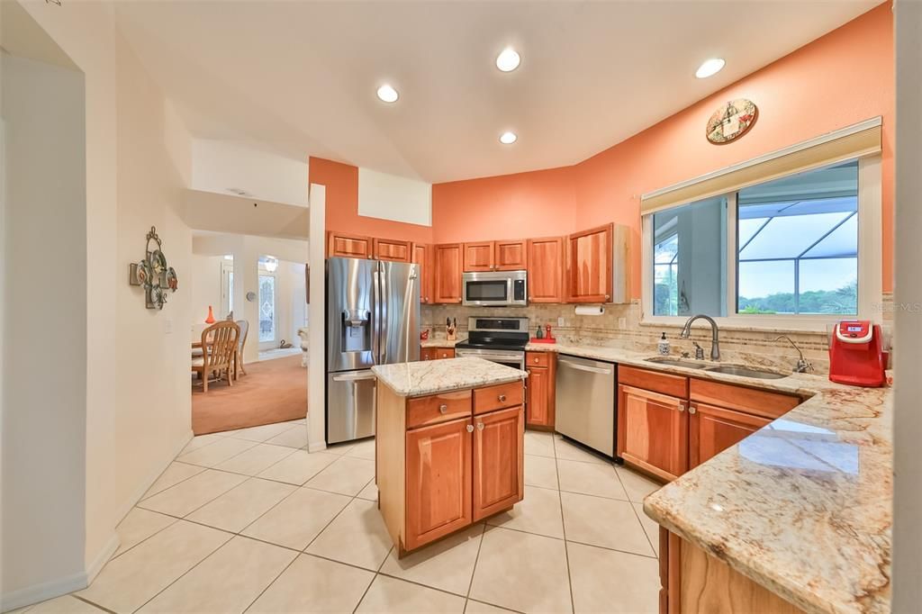 The kitchen boasts of NEW stainless steel appliances. large windows, all wood cabinets and granite countertops.