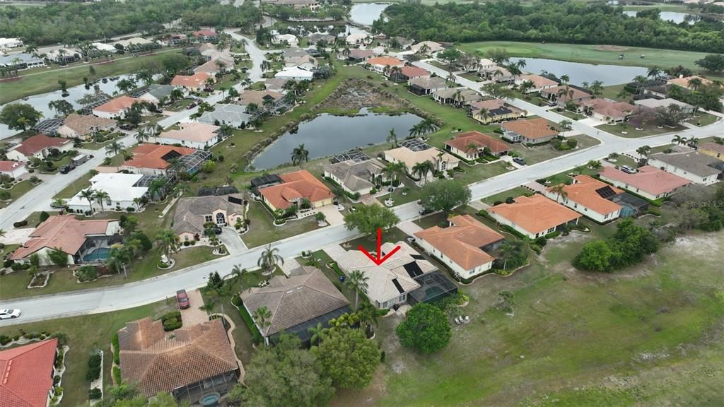Ariel view of community with home outlined with the red arrow