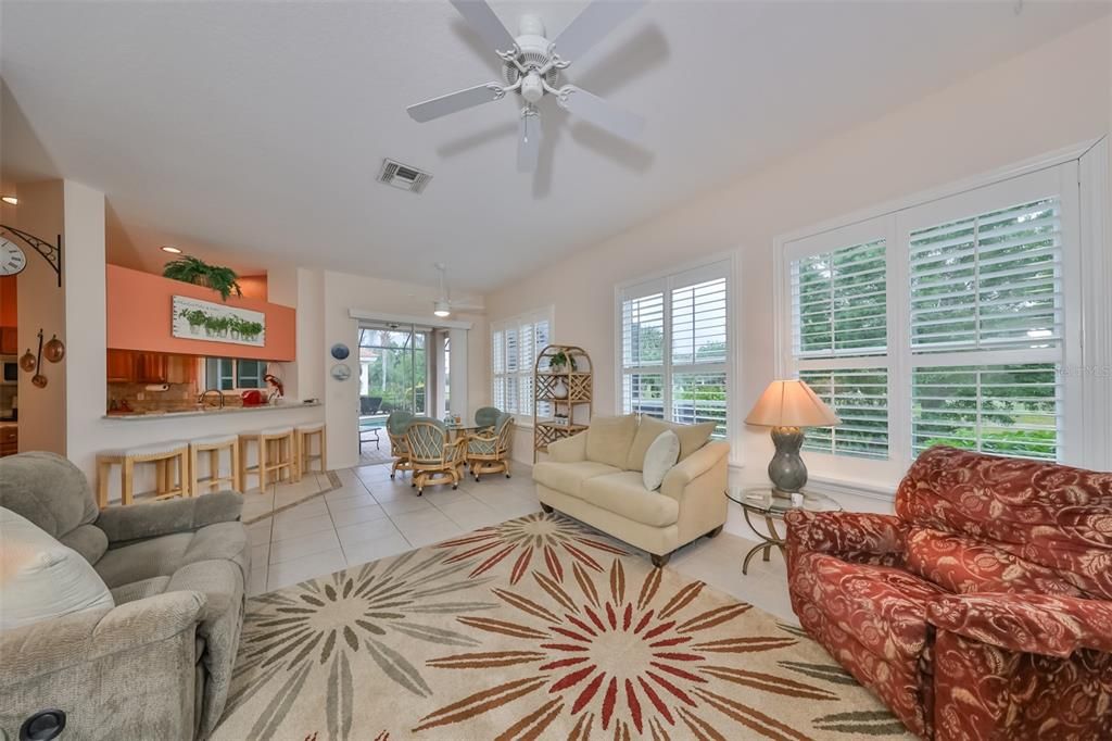Plantation shutters, high ceilings, and hurricane windows, this is a perfect space to enjoy overlooking the lanai, pool and golf course.