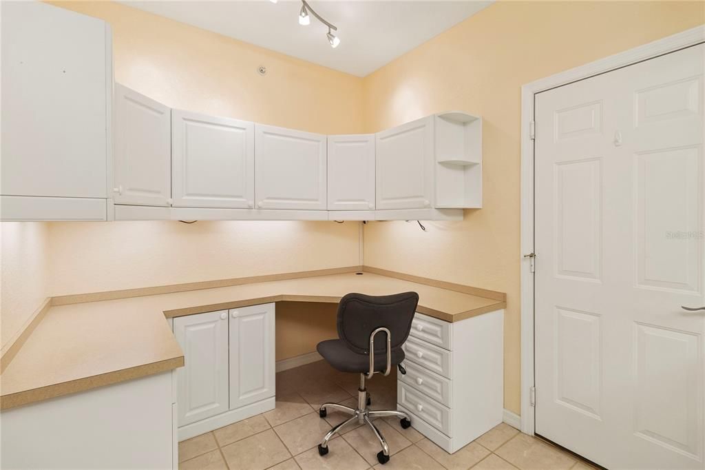 Extra cabinets and desk area in kitchen.