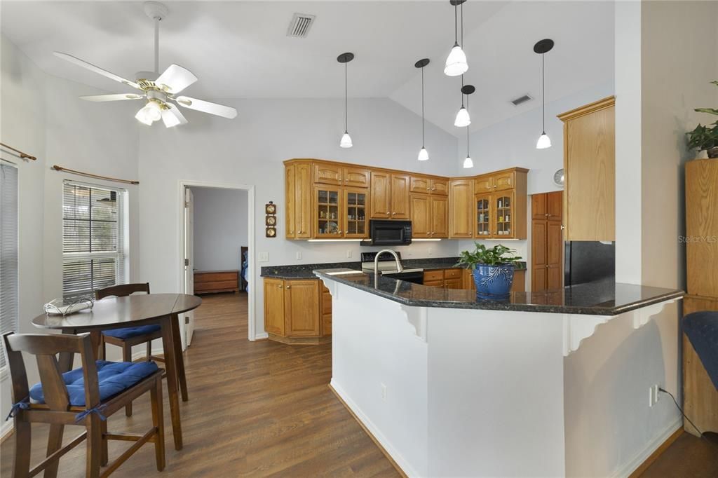The family chef will appreciate the well appointed eat-in kitchen featuring a great mix of cabinet and drawer storage, GRANITE COUNTERS, pendant lighting and breakfast bar as well as dinette seating for casual dining with views of the pool!