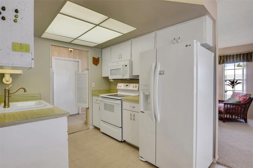 Galley style kitchen. Ample cabinet space, and don't forget there is shelving in the laundry for extra storage.