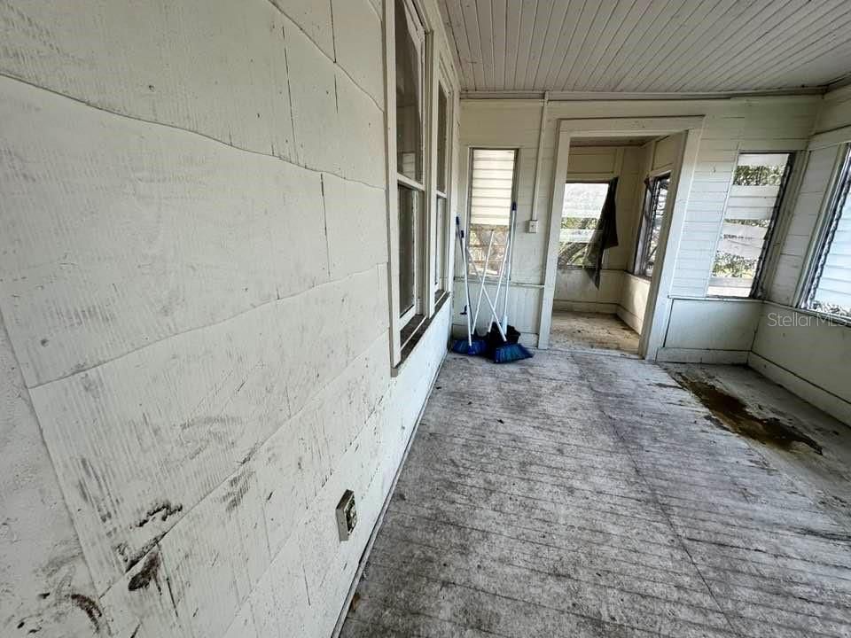 Front enclosed porch upstairs - floor needs repair and refinishing