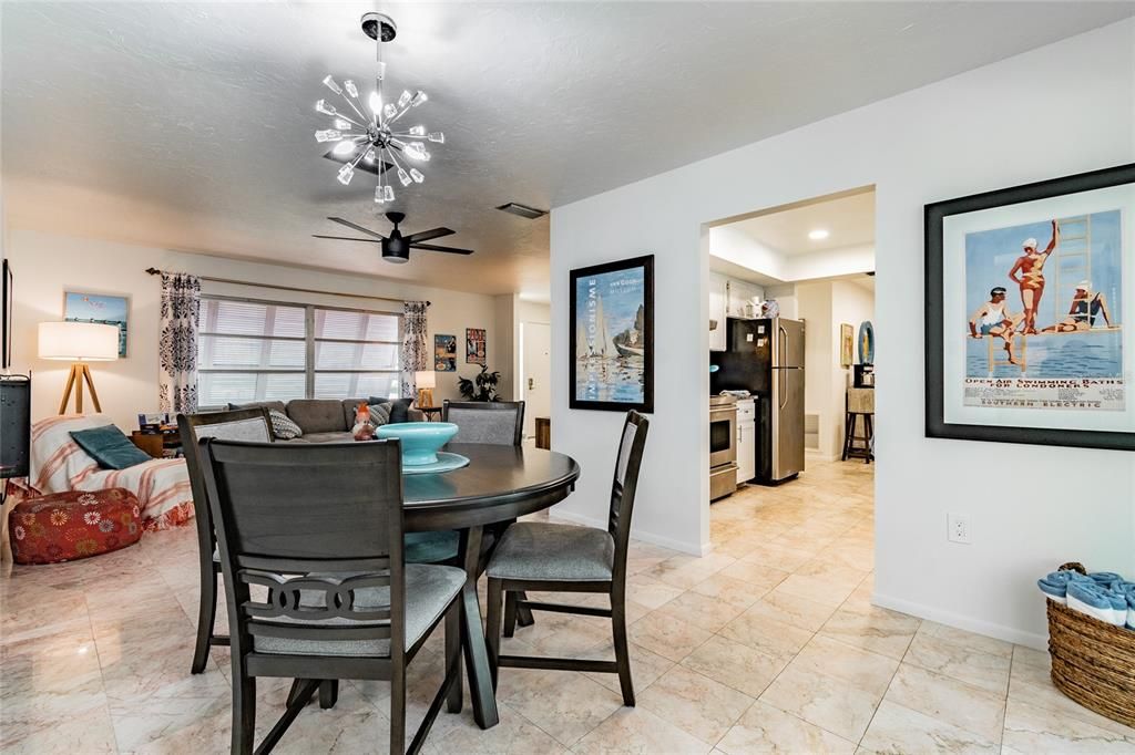 Dining area looks out over pool and patio area. With patio doors