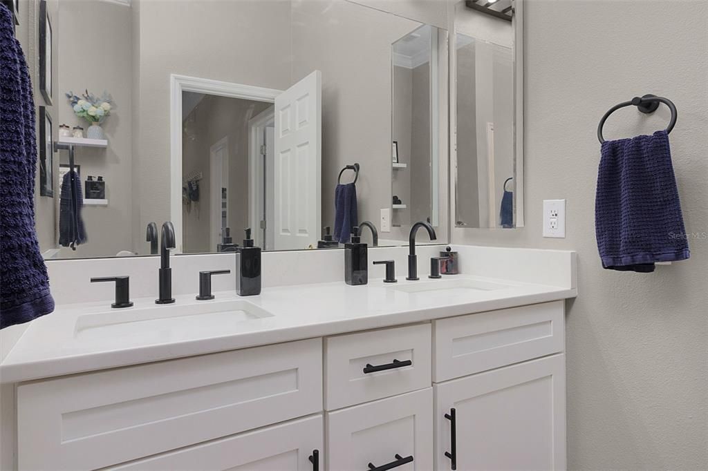 Updated bathroom 2 featuring a double vanity in the same nook as bedrooms 2 and 3 for convenience