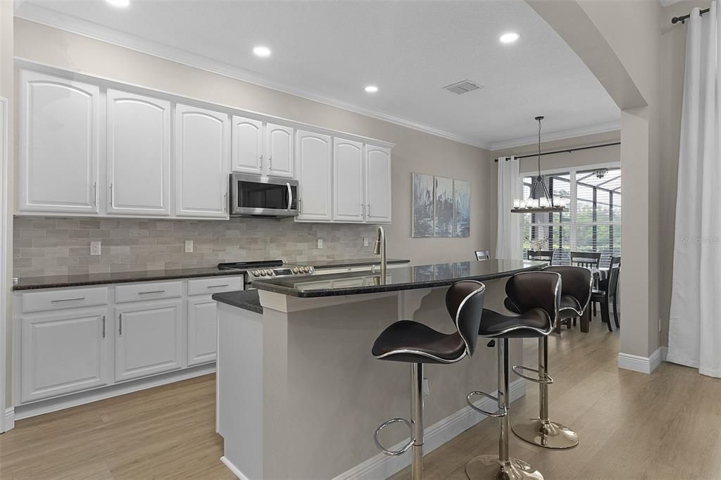 Huge kitchen with counterspace galore, ample cabinets, and a breakfast bar island