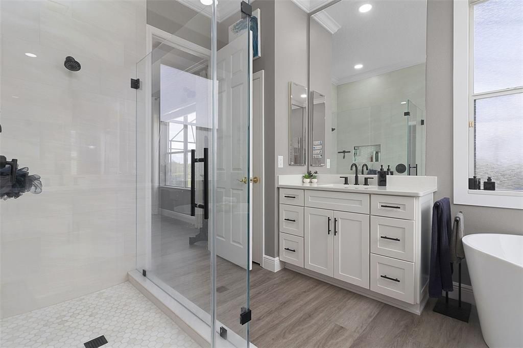 Glass enclosed shower with floor to ceiling tile