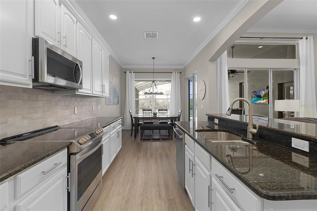 Stainless steel appliances, recessed lighting, and a view