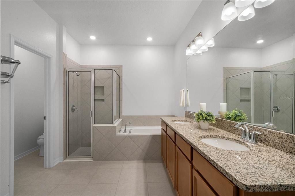 The junior ensuite bath features a dual vanity, soaking tub and shower.