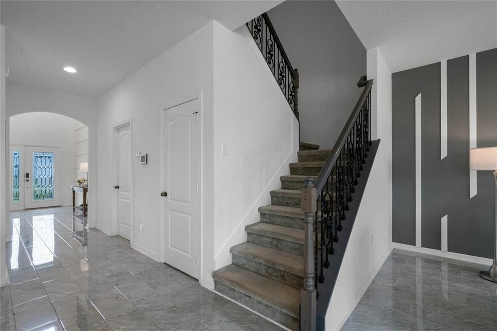 The custom wrought iron staircase leads you to the second story.