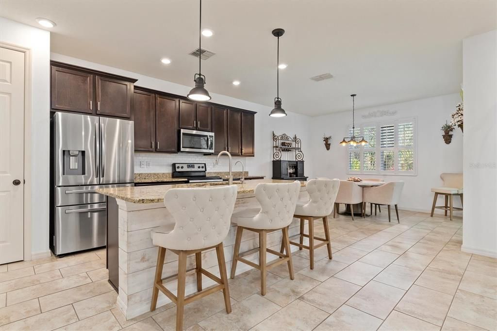 Newer stainless steel appliances and granite countertops with breakfast bar is perfect for a quick bite or for interacting with your family and guests.