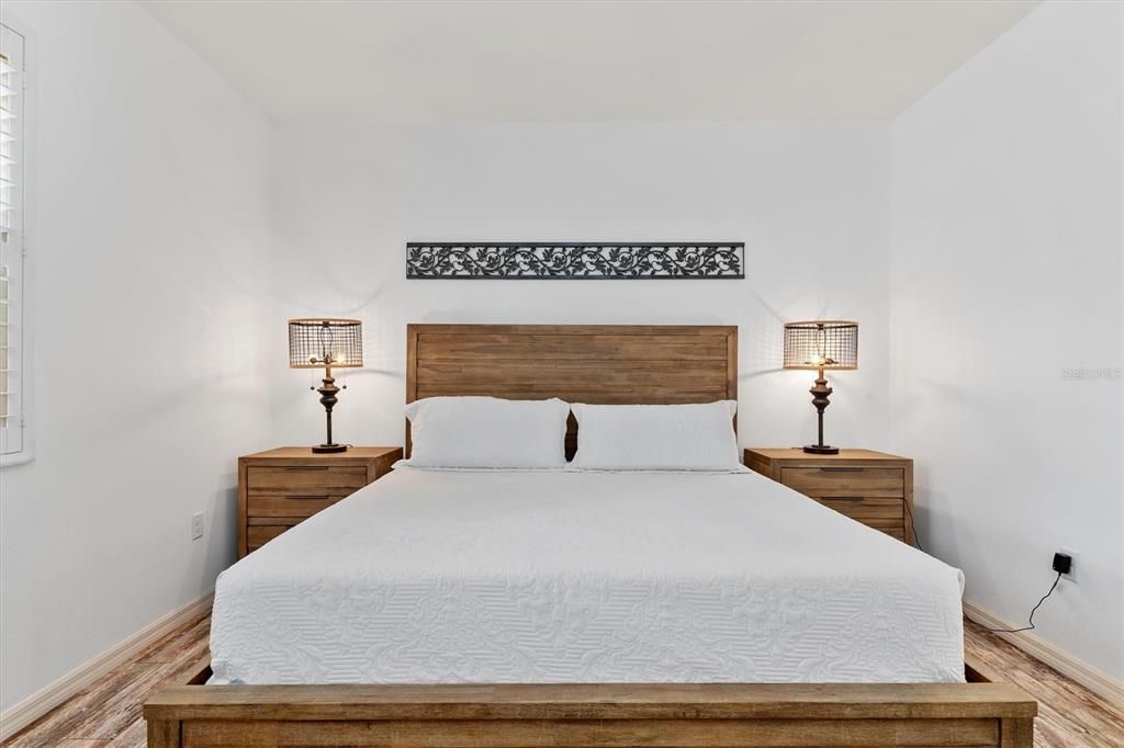 Newer flooring sets the warm tone for this spacious bedroom.