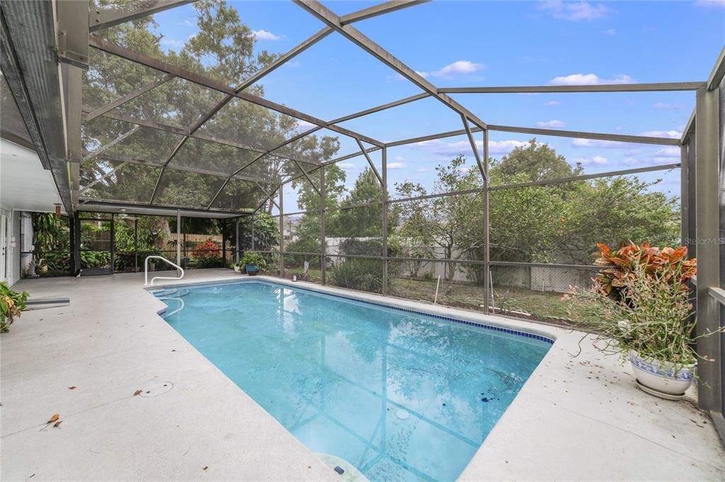 Relax poolside with your favorite beverage while you contemplate the updates you want to make inside, the covered lanai, screened pool and fenced yard beyond are ready for you to bring your lounge chairs, barbeque and let the fun begin!