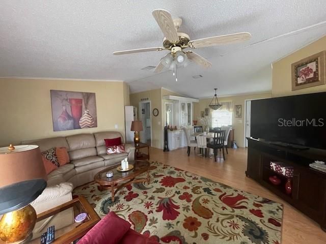 living room with slider that opens to screened in front porch