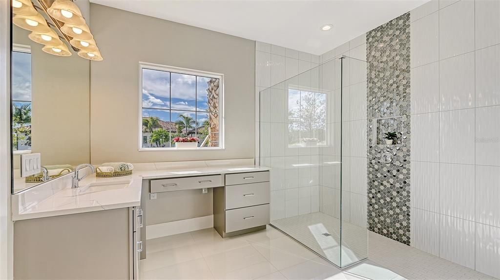 Lovely walk-in shower and another view of your vanity desk and drawers with separate sink.