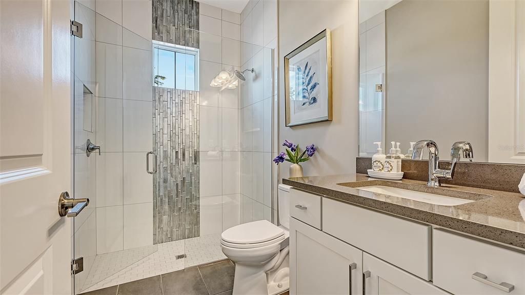This guest bathroom is in the hallway by the kitchen.  Convenient to the pool, living areas and bonus room.