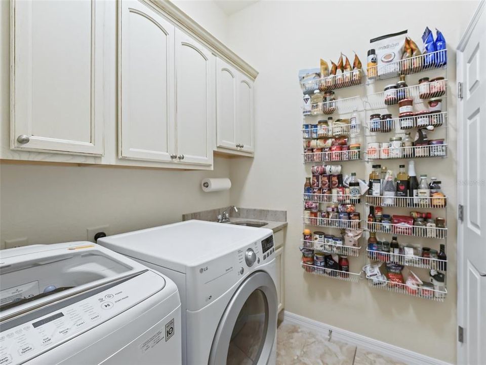 Inside laundry room w/utility sink & extra cabinets