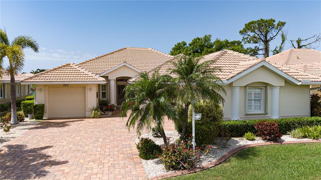 Great curb appeal, pavers plus a golf cart garage for all your toys.