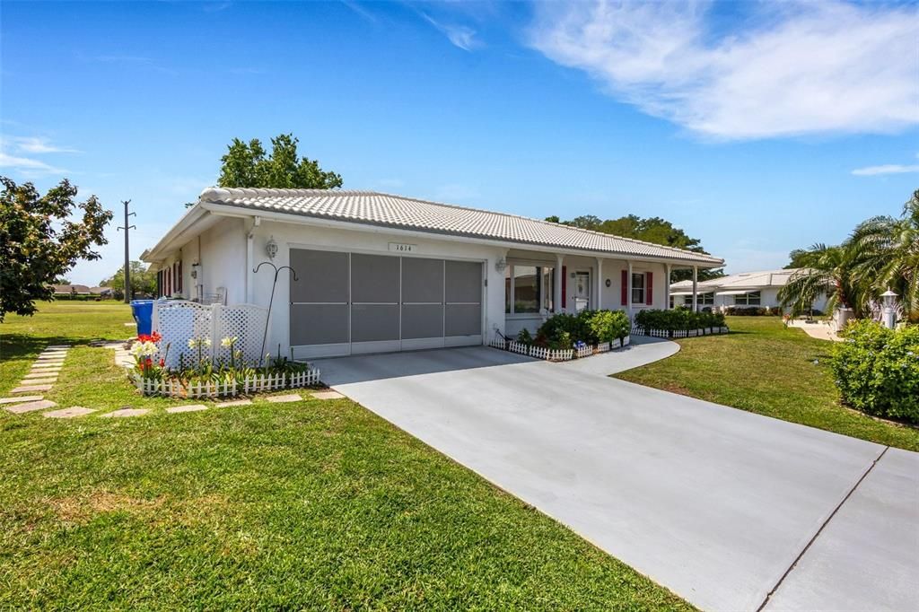 White tile roof which helps to reflect the suns rays aiding in keeping the house cooler than a conventional dark shingle roof. 2 car garage, or 1 car with golf cart. Slider garage screen doors.  Ample off street parking for visitors.