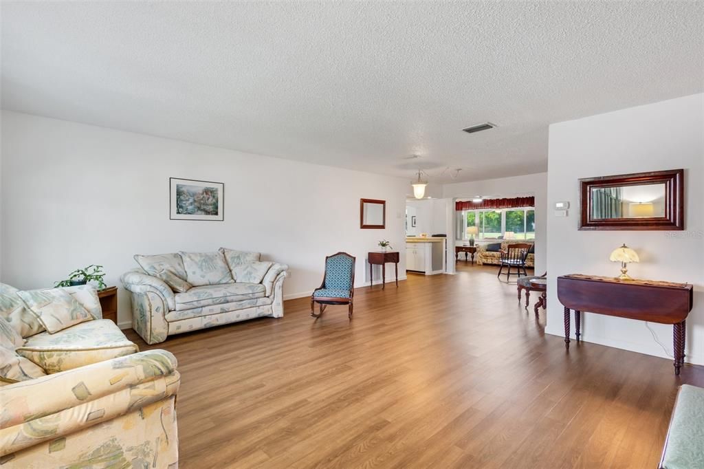 Enter to the spacious Living Room/Dining Room combination. Notice the warm woodgrain Cortec vinyl flooring. Furniture looks sparce because...you guessed it...the owners are moving.