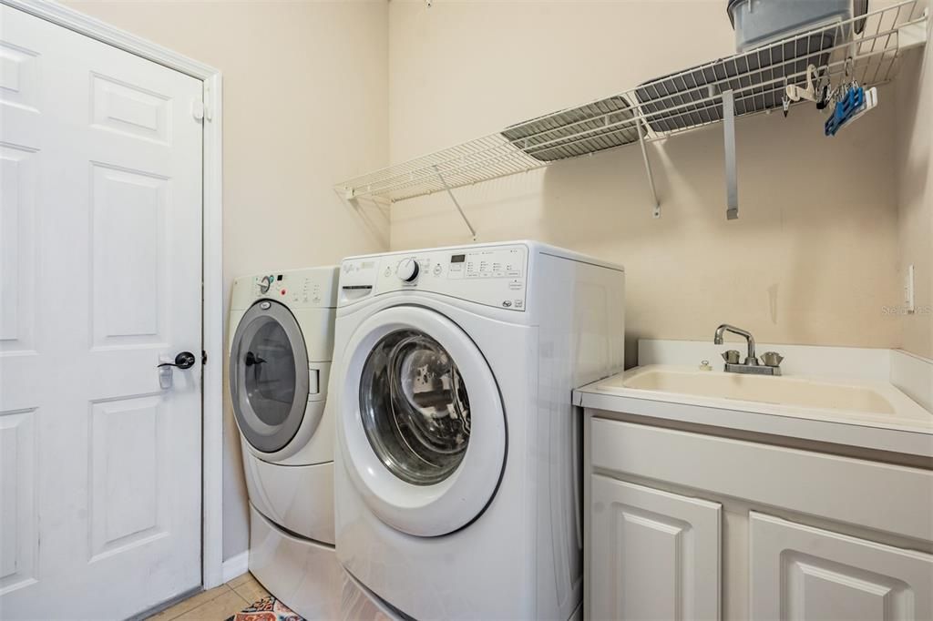 interior laundry room with utility sink downstairs