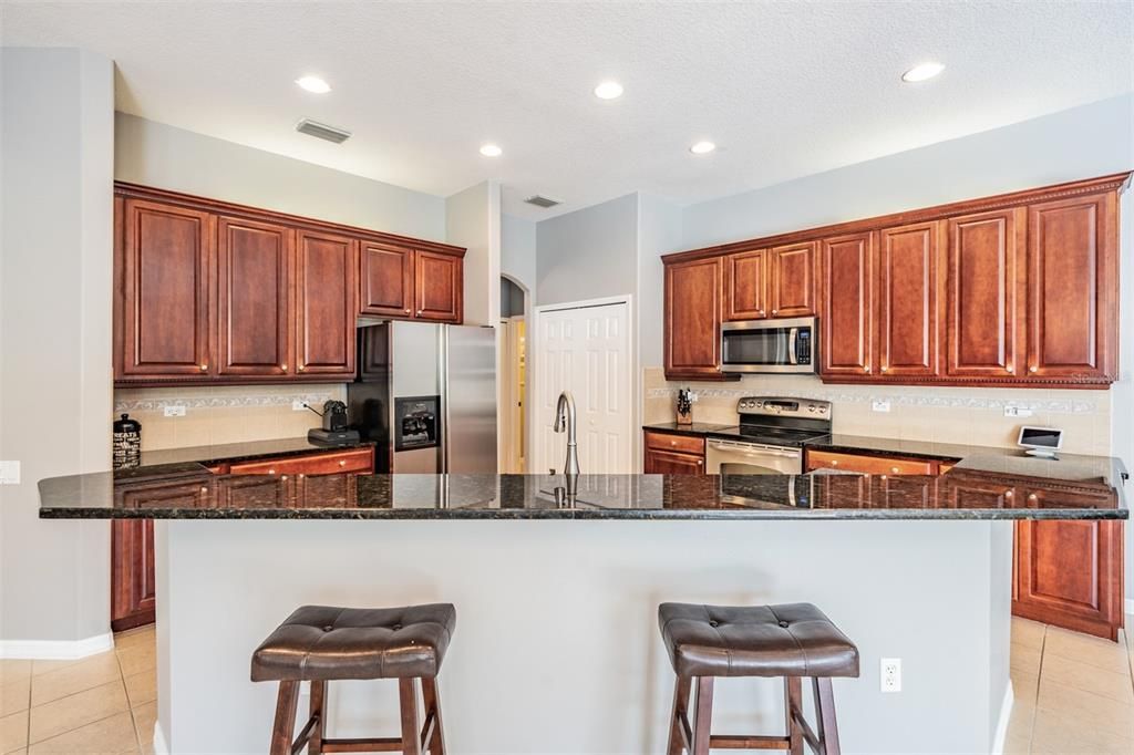 Granite counters and breakfast bar in Spacious kitchen