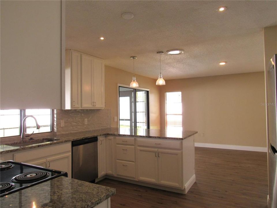 Kitchen Open To Large Dining Area With Glass Sliding Doors To 11 x 33 Screen Enclosed Lanai.